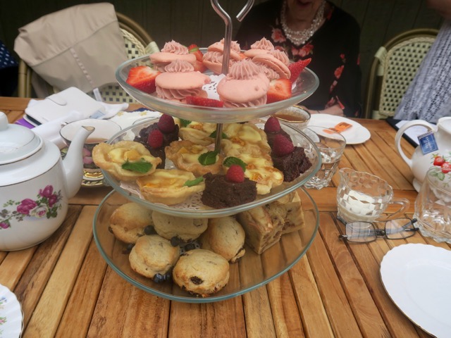 and then served with a three-tier dessert stand filled with scones and sweets 
